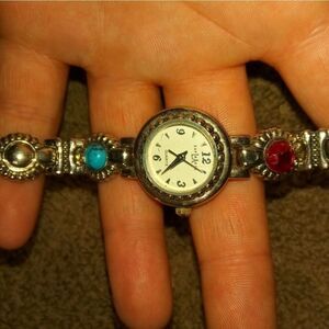EXPLRAESS silver tone watch with a red and blue st